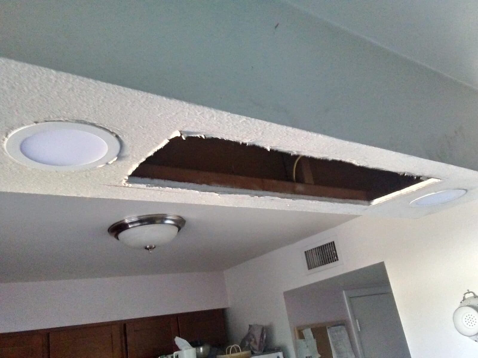 Before: Ceiling opened and rough opening prepared for new rangehood