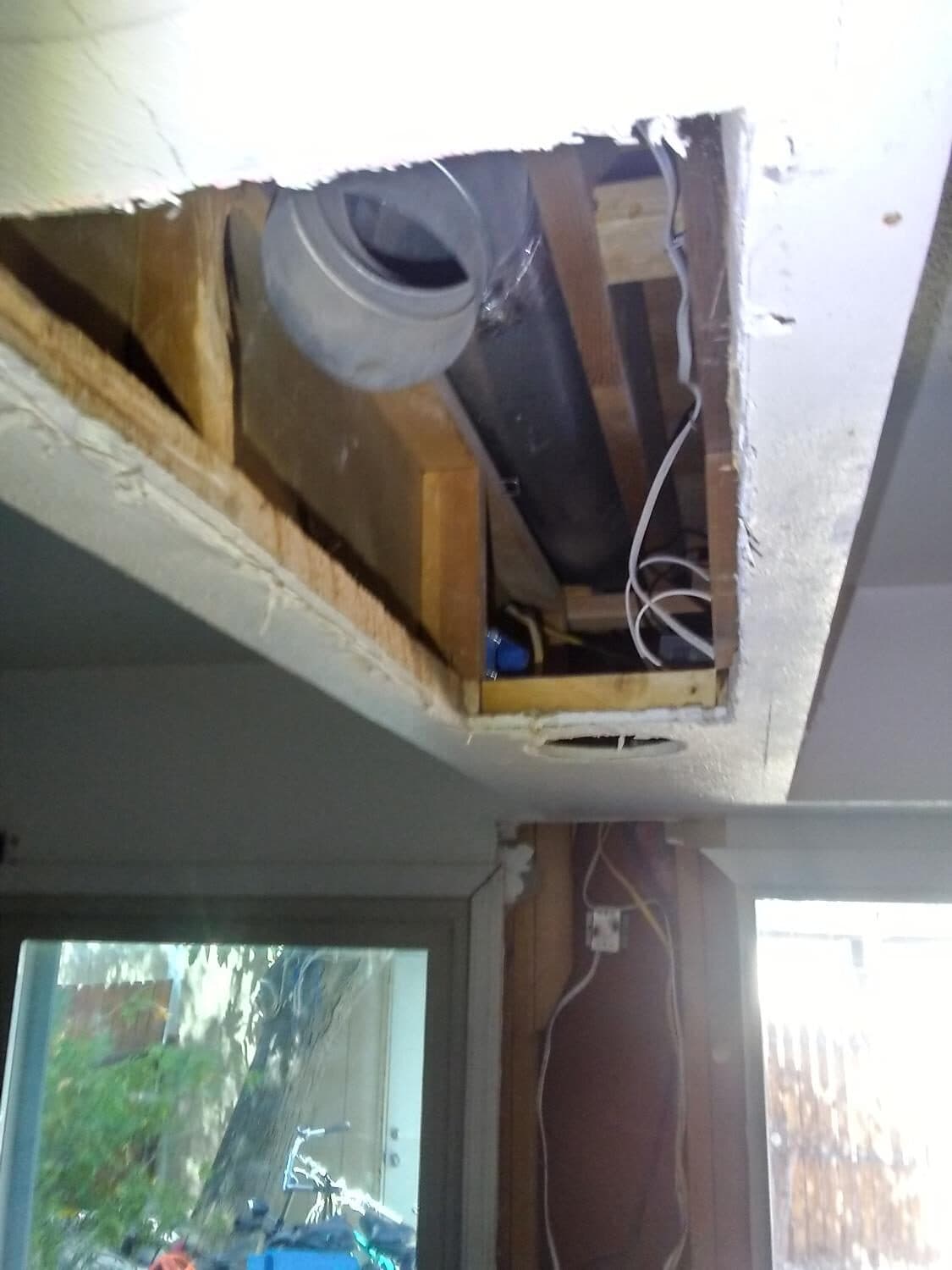 Wire routed into the soffit. Receptacle left accessible through the LED cut-out so the rangehood stays plugged in (hardwiring voids the manufacturer warranty).