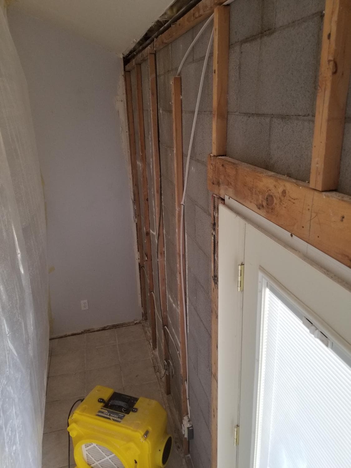 During: remediation starts with the damaged drywall opened up so the problem area can be corrected properly.